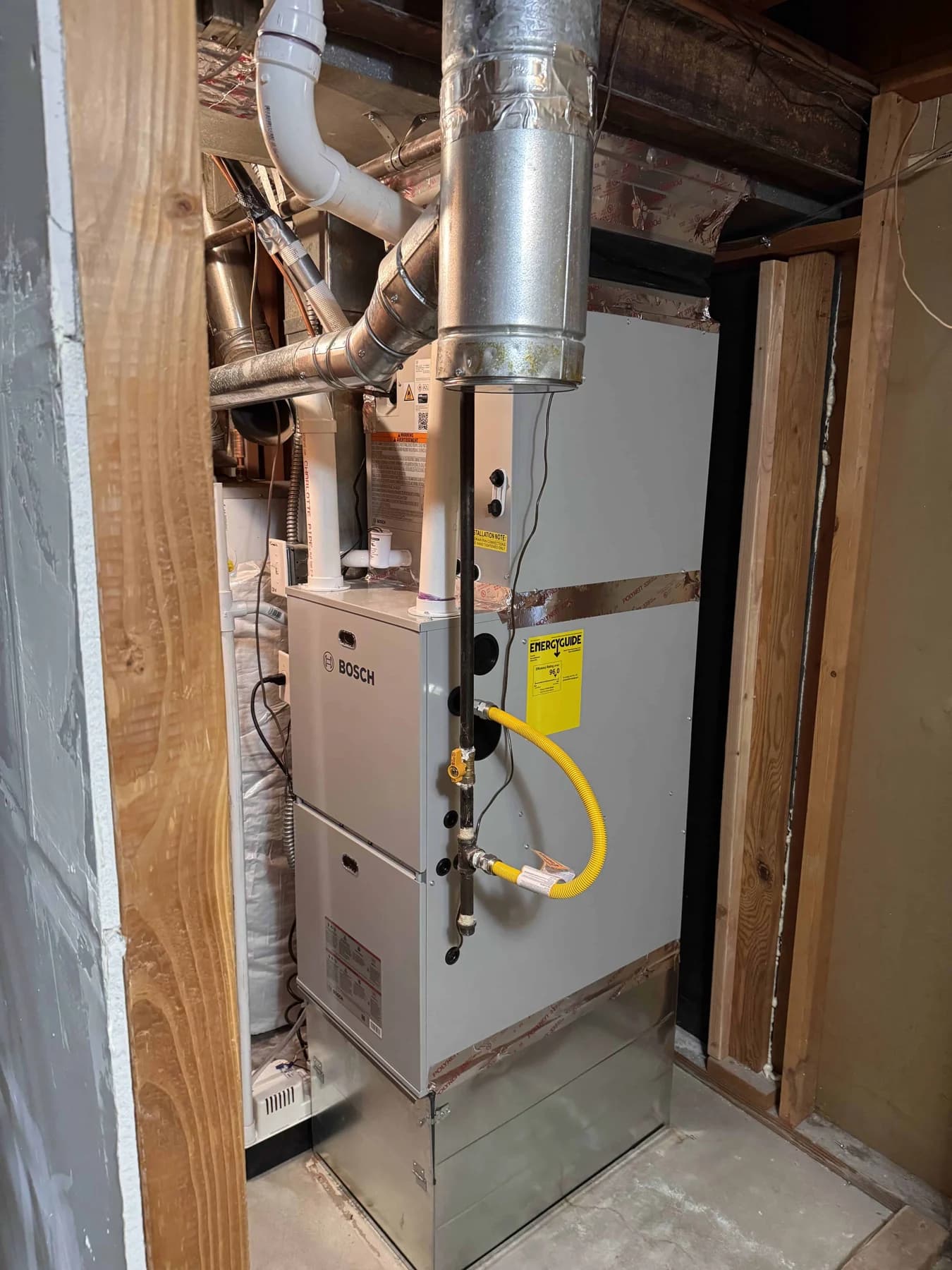 Furnace below a cooling coil and ductwork in an equipment room