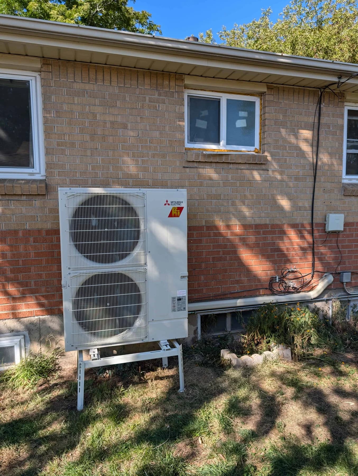 mitsubishi outdoor condenser brick house yellow trim